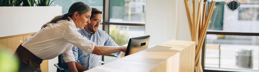 Cybersecurity professionals looking at information on a computer screen