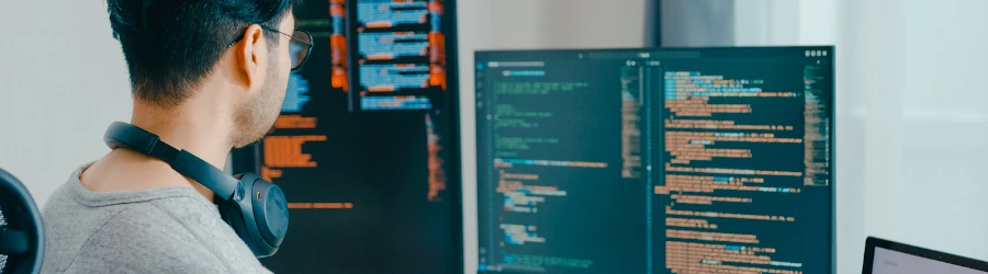 Bachelor's student working on a cybersecurity project on his computer